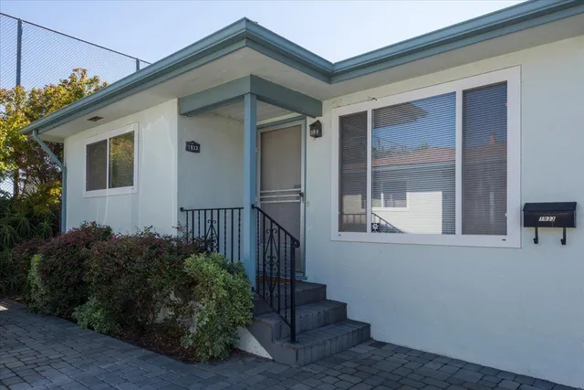 a view of a house with wooden fence and windows