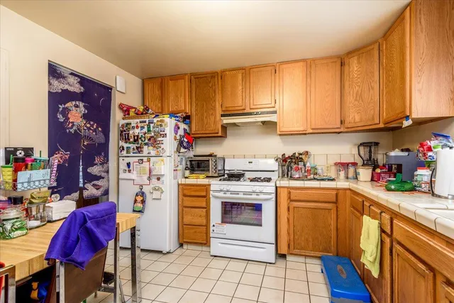 a kitchen with stainless steel appliances granite countertop a refrigerator sink and cabinets