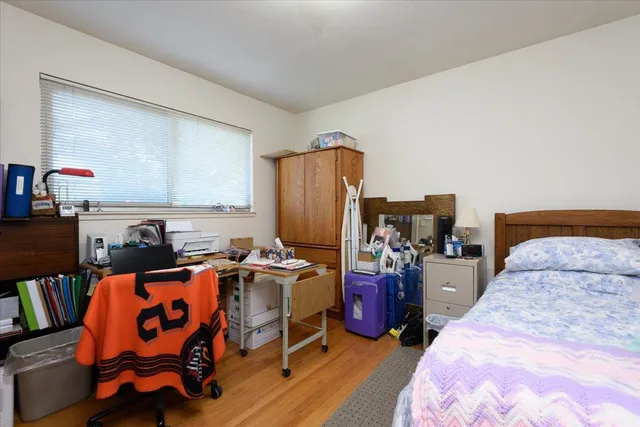 a bedroom with furniture and a book shelf