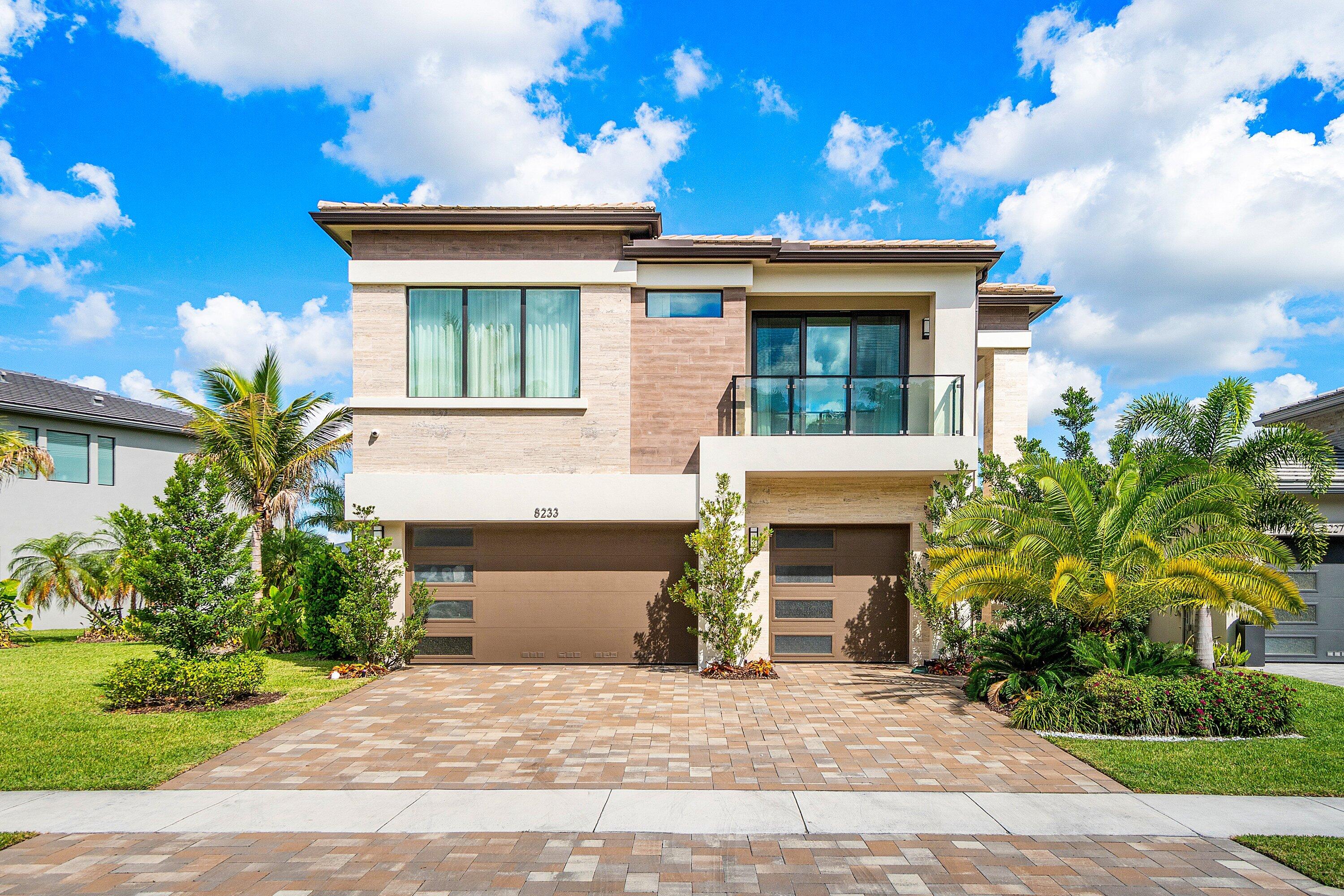 8233 Crystal Downs Avenue Boca Raton, FL 33434 - Photo 1 of 58 a front view of a house with yard and parking