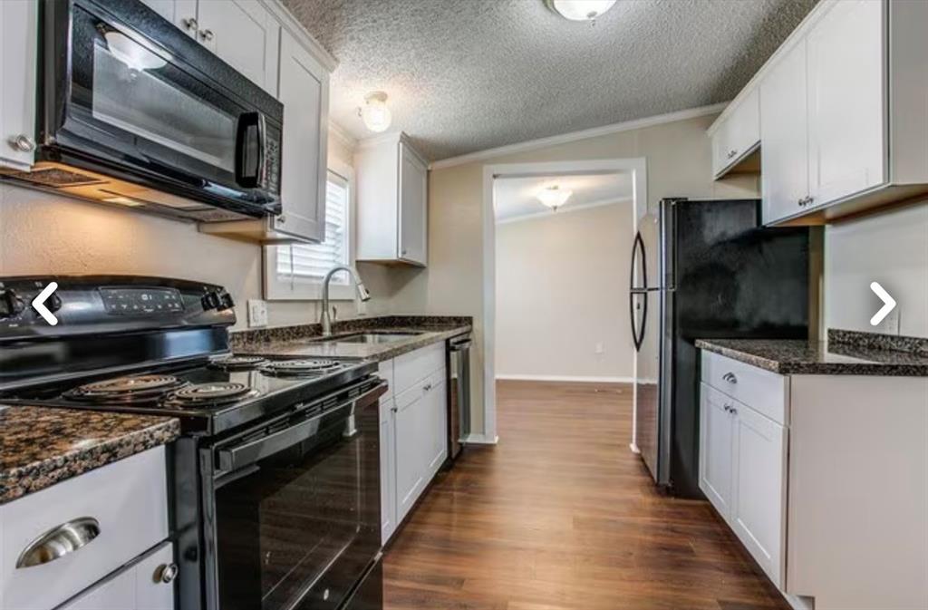 168 Prairie Lane Azle, TX 76020 - Photo 8 of 16 Kitchen featuring ornamental molding, black appliances, white cabinetry, dark wood-style flooring, and dark stone countertops