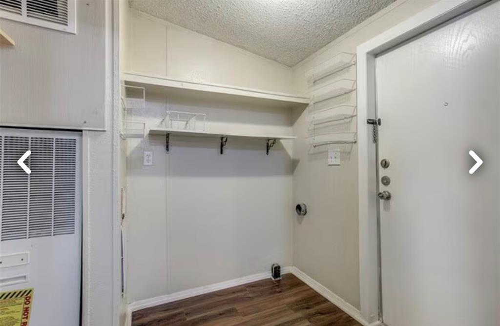 168 Prairie Lane Azle, TX 76020 - Photo 9 of 16 Laundry area featuring a heating unit, dark wood-style floors, and a textured ceiling