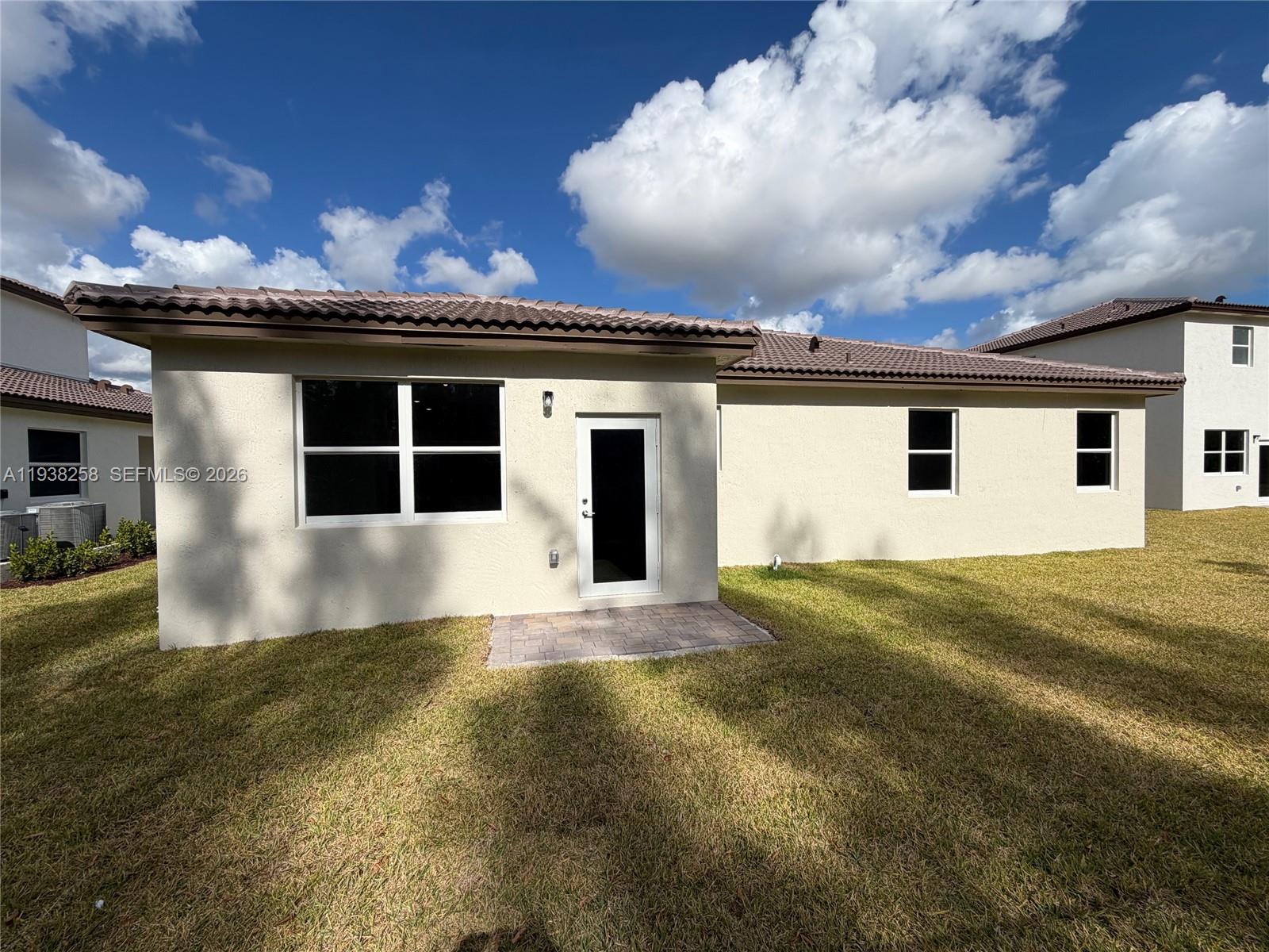 2256 Southeast 30th Street, Unit 2256 Homestead, FL 33035 - Photo 11 of 29 a front view of a house with a yard