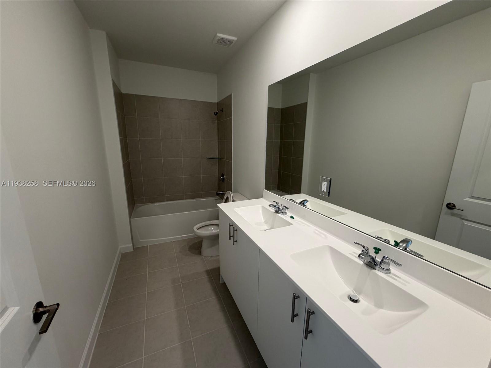 2256 Southeast 30th Street, Unit 2256 Homestead, FL 33035 - Photo 12 of 29 a bathroom with a double vanity sink and mirror