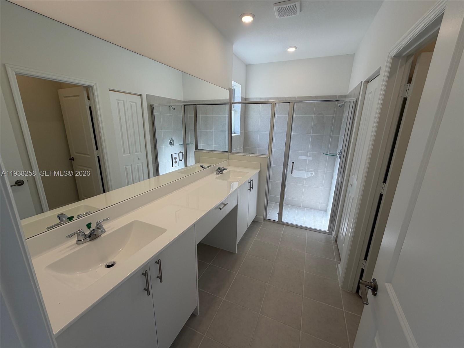 2256 Southeast 30th Street, Unit 2256 Homestead, FL 33035 - Photo 14 of 29 a bathroom with a double vanity sink and mirror