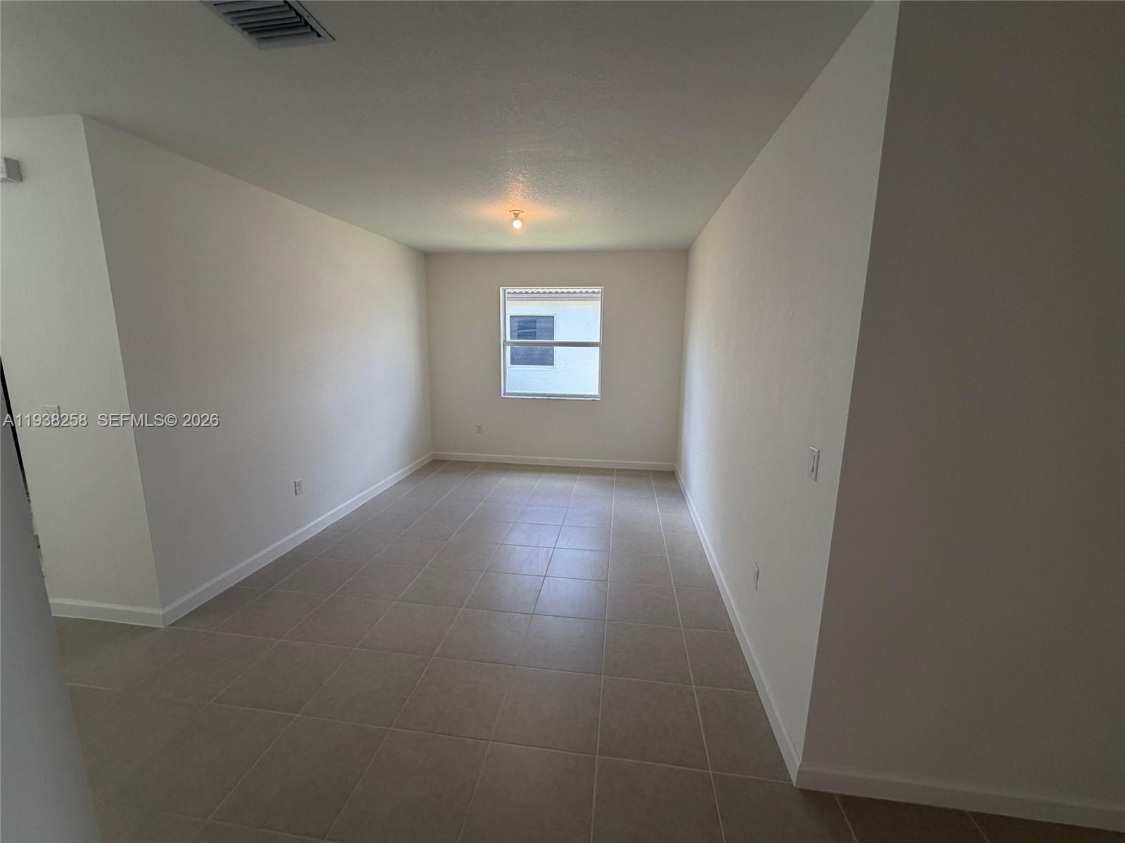 2256 Southeast 30th Street, Unit 2256 Homestead, FL 33035 - Photo 15 of 29 an empty room with wooden floor and windows