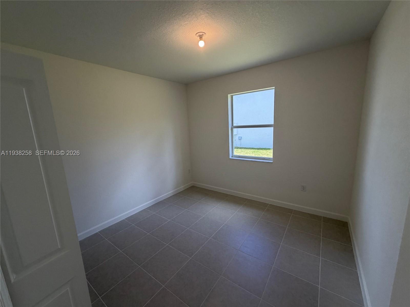 2256 Southeast 30th Street, Unit 2256 Homestead, FL 33035 - Photo 20 of 29 an empty room with a window