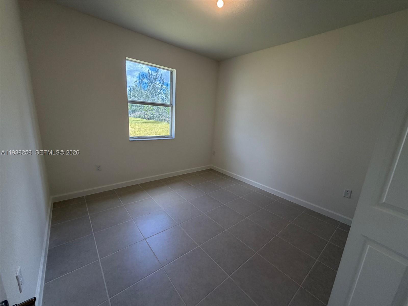 2256 Southeast 30th Street, Unit 2256 Homestead, FL 33035 - Photo 21 of 29 an empty room with a window