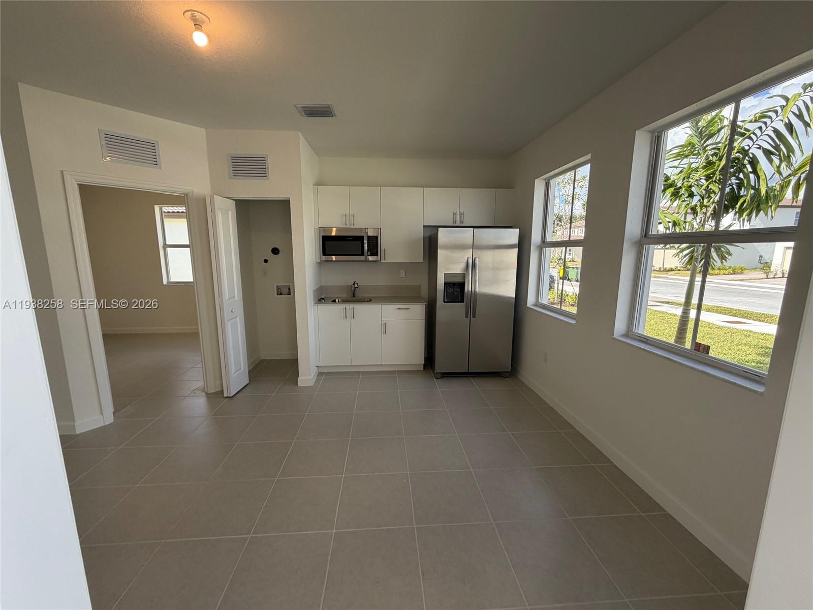 2256 Southeast 30th Street, Unit 2256 Homestead, FL 33035 - Photo 22 of 29 a view of a kitchen with refrigerator and windows