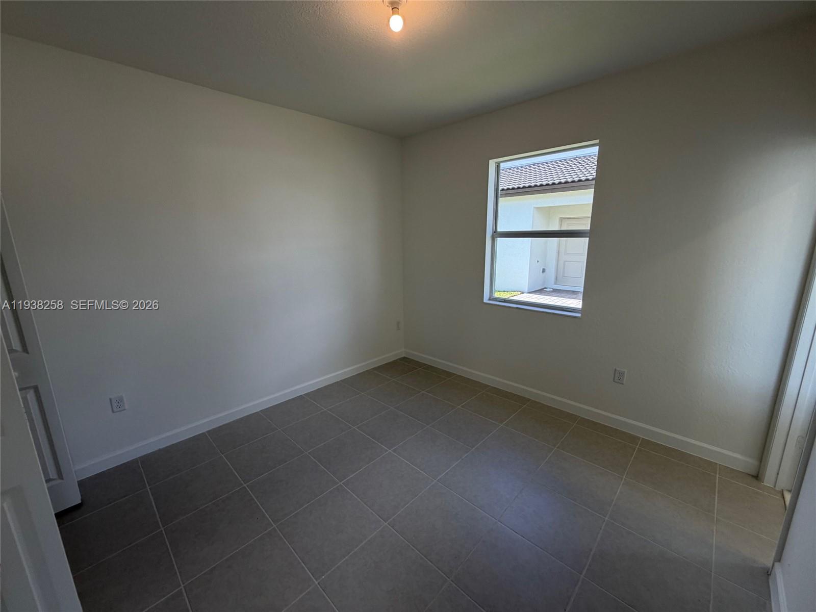 2256 Southeast 30th Street, Unit 2256 Homestead, FL 33035 - Photo 24 of 29 an empty room with a window