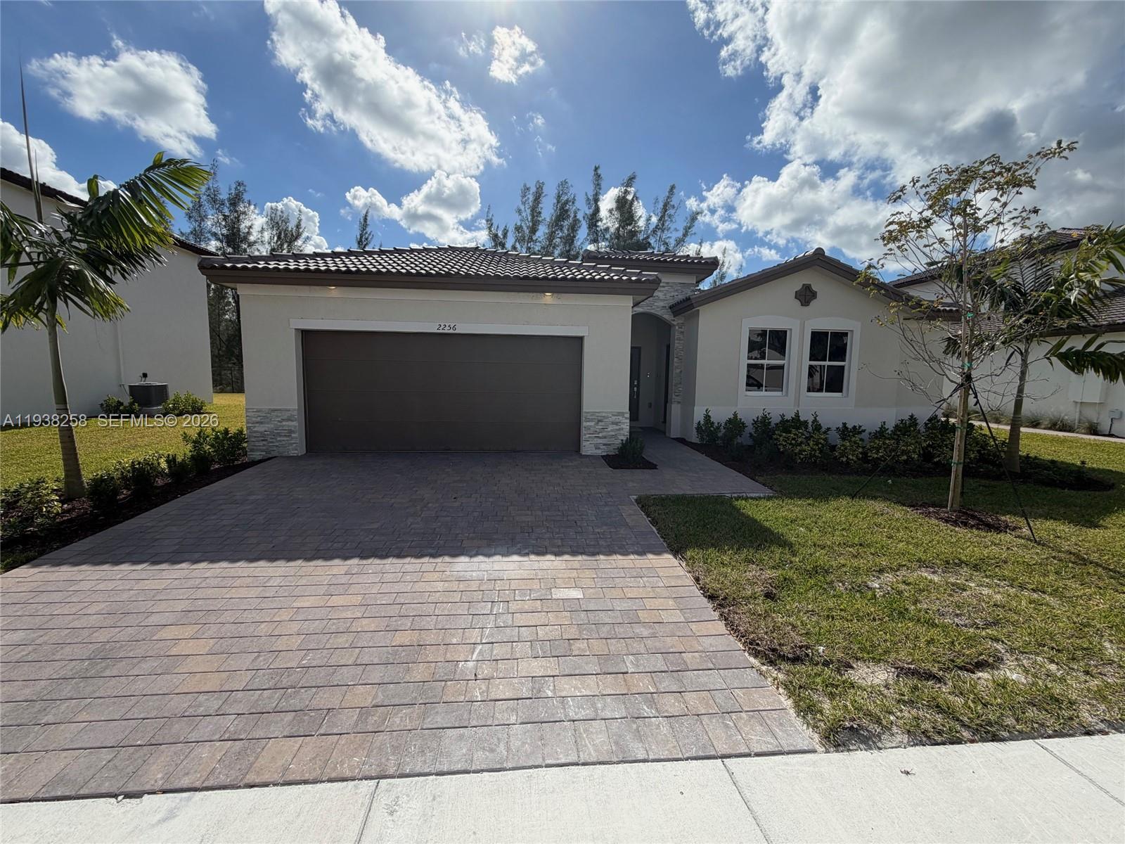2256 Southeast 30th Street, Unit 2256 Homestead, FL 33035 - Photo 27 of 29 a front view of a house with garden