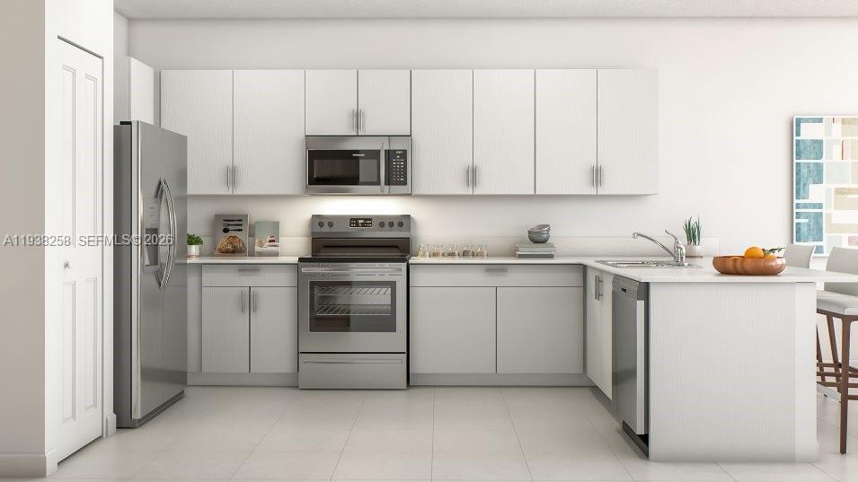 2256 Southeast 30th Street, Unit 2256 Homestead, FL 33035 - Photo 4 of 29 a kitchen with stainless steel appliances white cabinets and a refrigerator