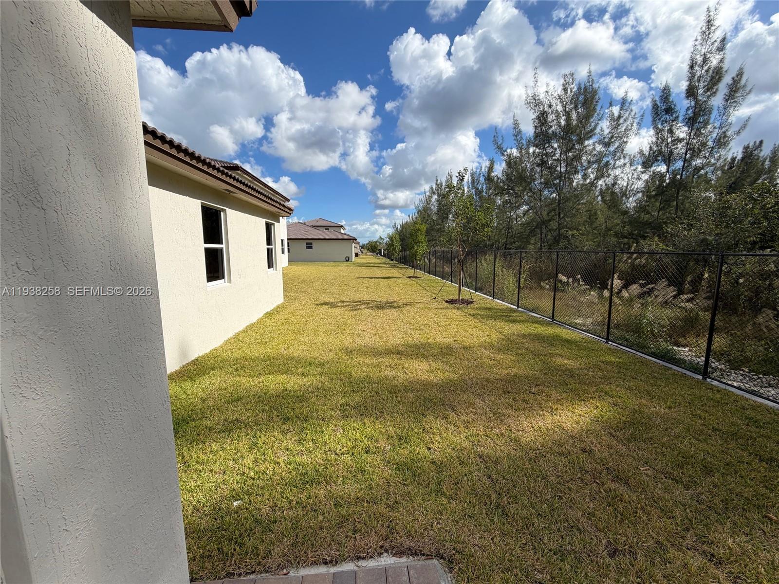 2256 Southeast 30th Street, Unit 2256 Homestead, FL 33035 - Photo 8 of 29 a yellow room with trees in the background