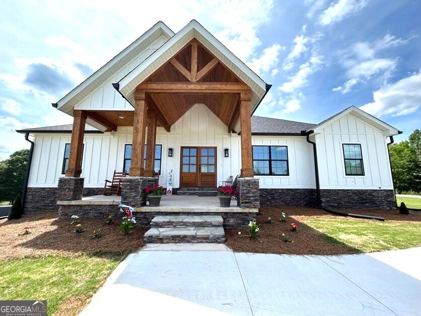 a front view of house with yard outdoor seating and barbeque oven