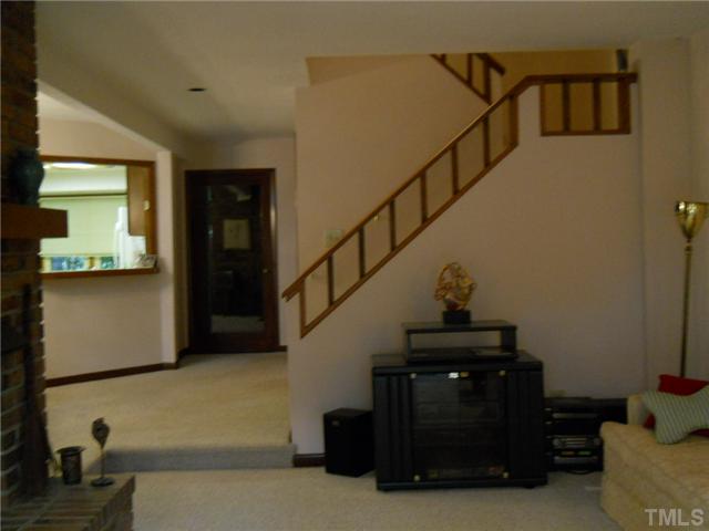 4347 Sunscape Lane Raleigh, NC 27613 - Photo 3 of 14 View of stairway and front door from living room.