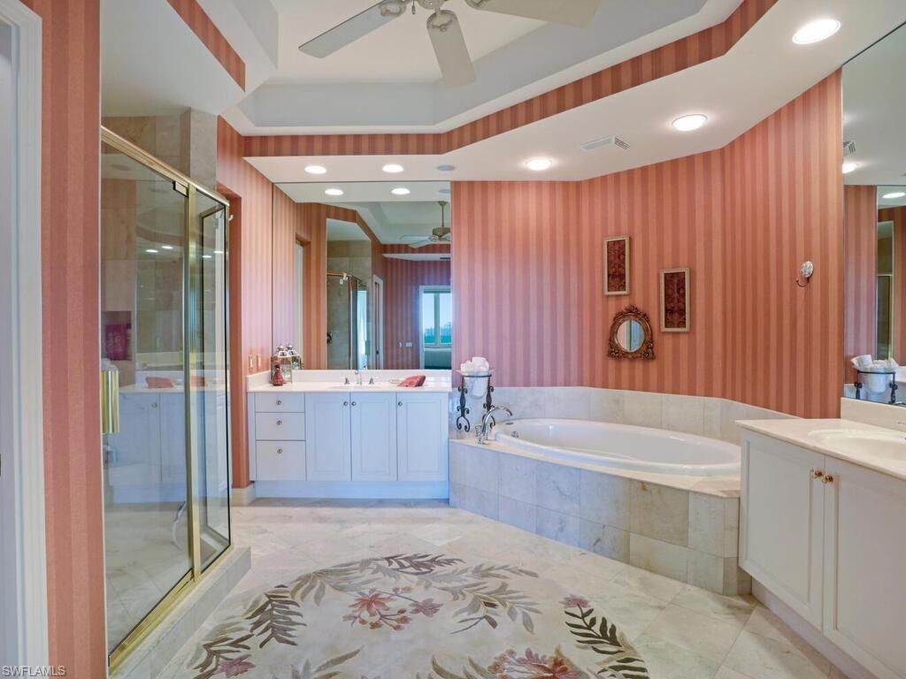 425 Dockside Drive, Unit PH1 Naples, FL 34110 - Photo 15 of 34 a bathroom with a bathtub and a shower