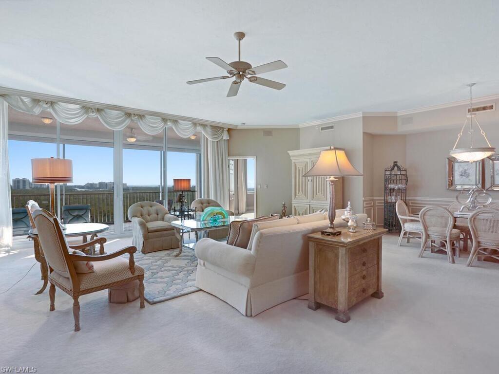 425 Dockside Drive, Unit PH1 Naples, FL 34110 - Photo 16 of 34 a living room with fireplace furniture and a large window