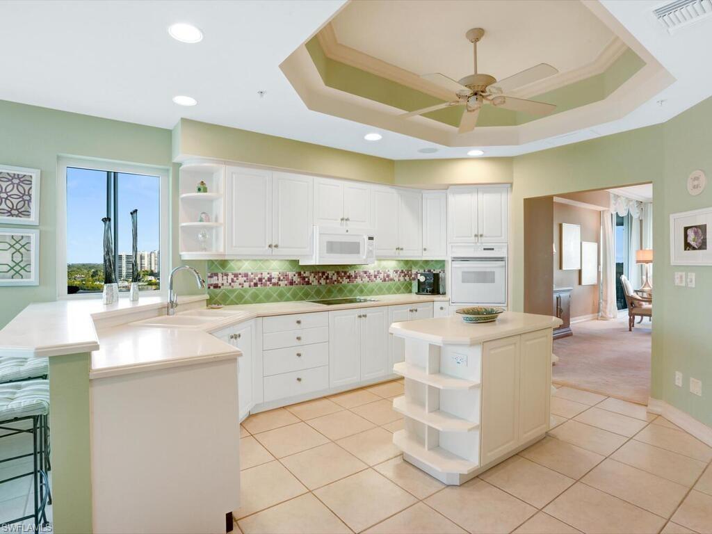 425 Dockside Drive, Unit PH1 Naples, FL 34110 - Photo 19 of 34 a kitchen with a sink and cabinets
