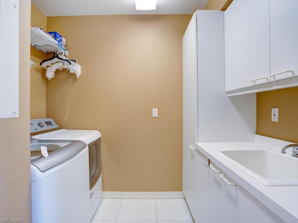 425 Dockside Drive, Unit PH1 Naples, FL 34110 - Photo 30 of 34 a utility room with dryer and washer