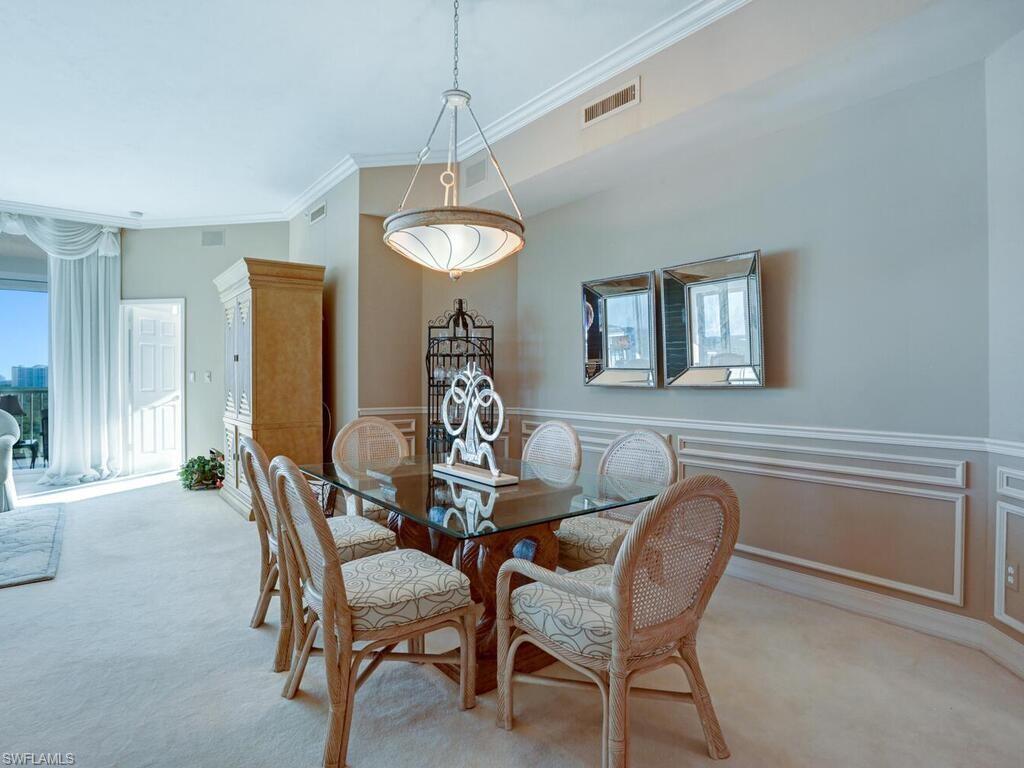 425 Dockside Drive, Unit PH1 Naples, FL 34110 - Photo 5 of 34 a view of a dining room with furniture and chandelier