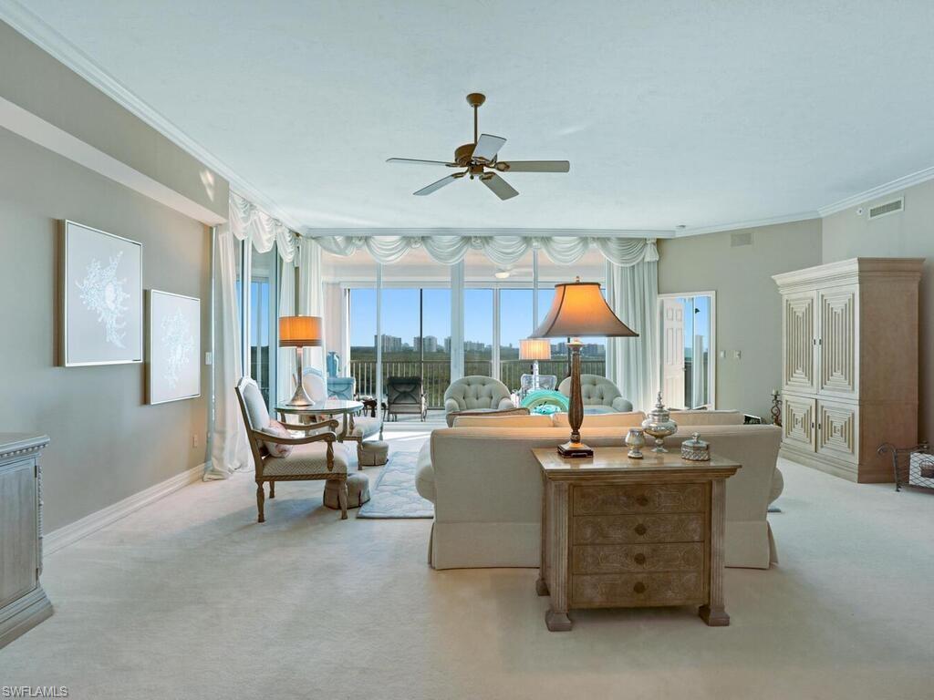 425 Dockside Drive, Unit PH1 Naples, FL 34110 - Photo 6 of 34 a living room with furniture a chandelier and a piano