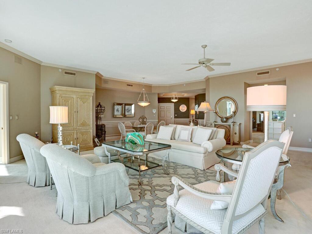 425 Dockside Drive, Unit PH1 Naples, FL 34110 - Photo 8 of 34 a living room with furniture and a large window