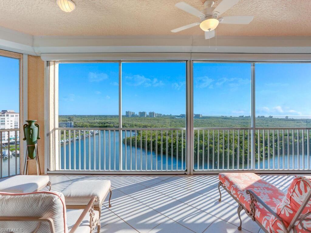 425 Dockside Drive, Unit PH1 Naples, FL 34110 - Photo 9 of 34 a balcony with table and chairs