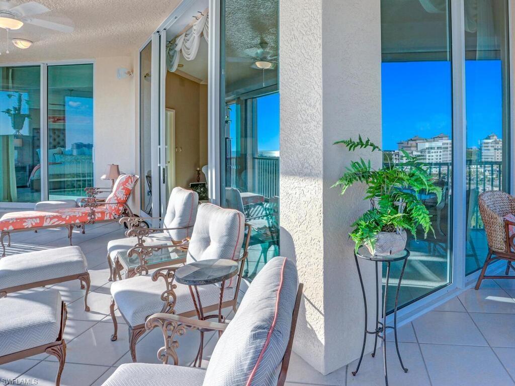 425 Dockside Drive, Unit PH1 Naples, FL 34110 - Photo 10 of 34 a dining room with furniture and outdoor view