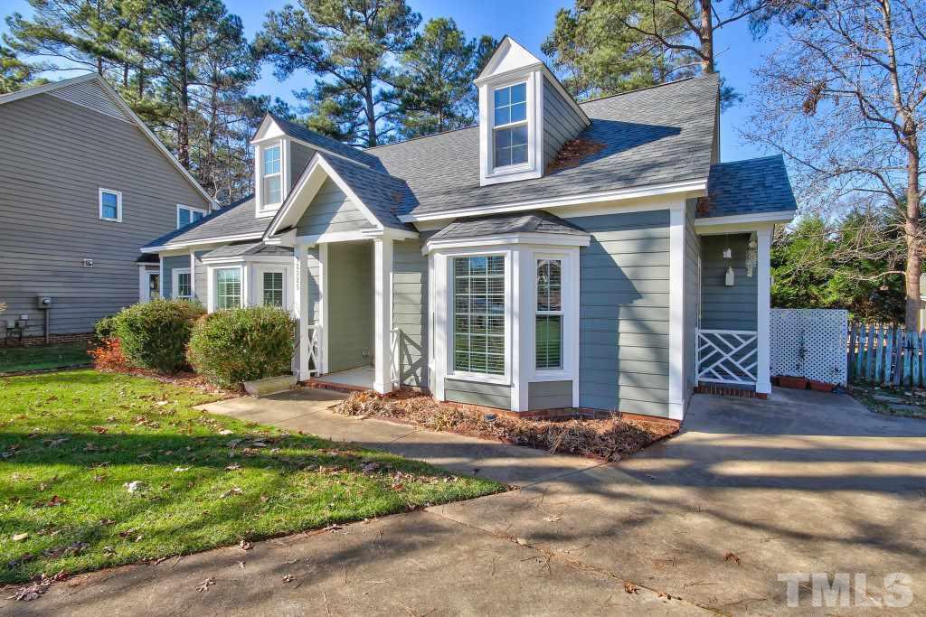 12225 Jarden Court Raleigh, NC 27613 - Photo 2 of 20 a front view of a house with a garden and plants