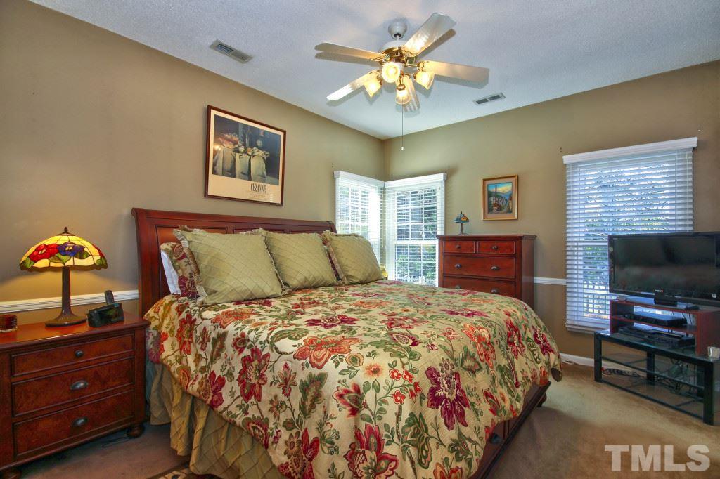 12225 Jarden Court Raleigh, NC 27613 - Photo 11 of 20 a bedroom with a bed and a flat screen tv
