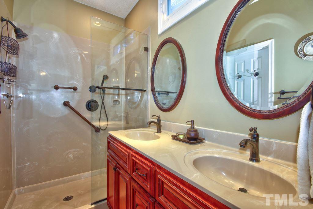 12225 Jarden Court Raleigh, NC 27613 - Photo 12 of 20 a bathroom with a double vanity sink and a mirror