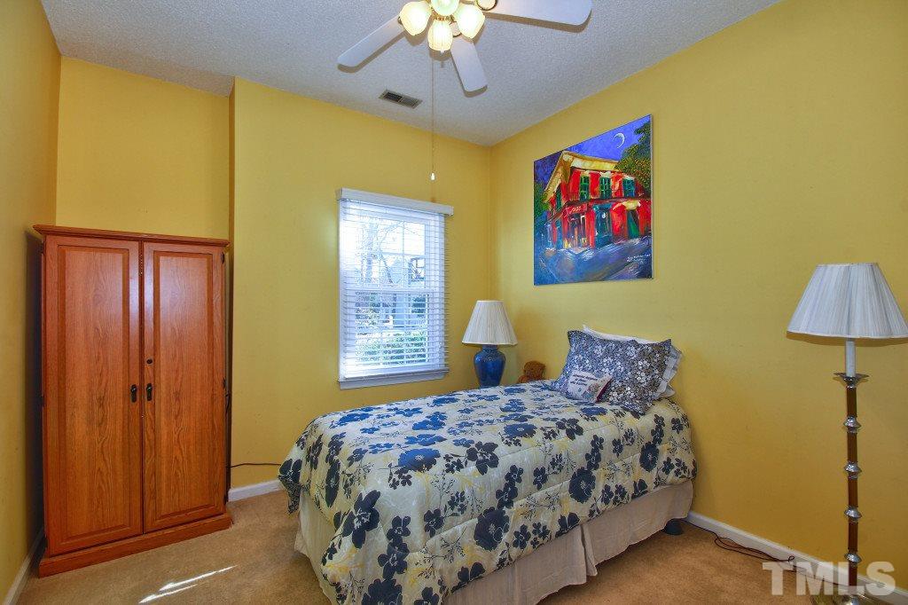 12225 Jarden Court Raleigh, NC 27613 - Photo 13 of 20 a bedroom with a bed and a chandelier