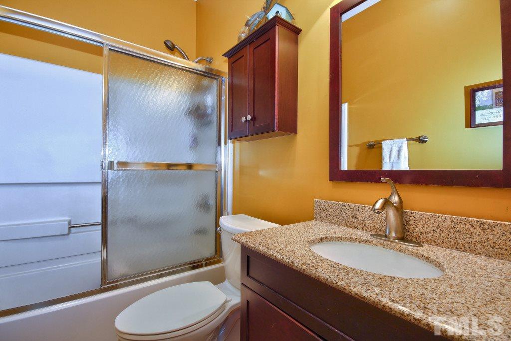 12225 Jarden Court Raleigh, NC 27613 - Photo 16 of 20 a bathroom with a granite countertop sink toilet and shower