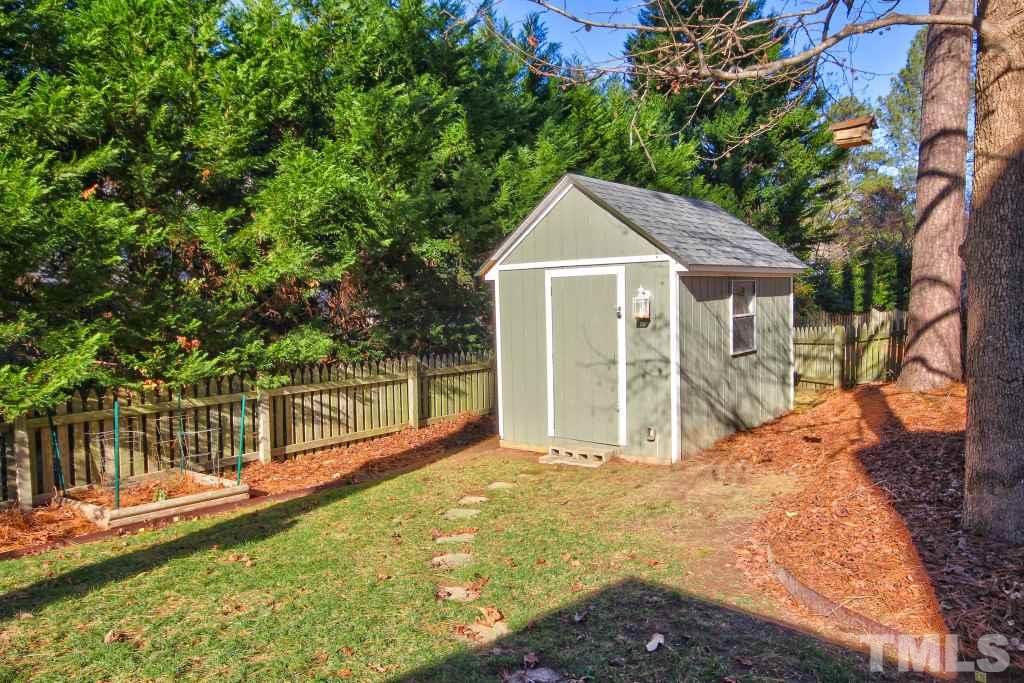 12225 Jarden Court Raleigh, NC 27613 - Photo 17 of 20 a view of a house with wooden fence next to a yard