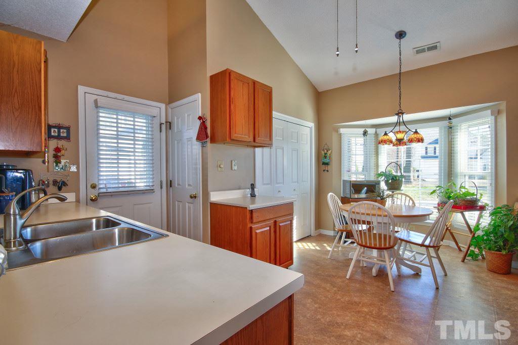 12225 Jarden Court Raleigh, NC 27613 - Photo 9 of 20 a kitchen with a table chairs sink and cabinets