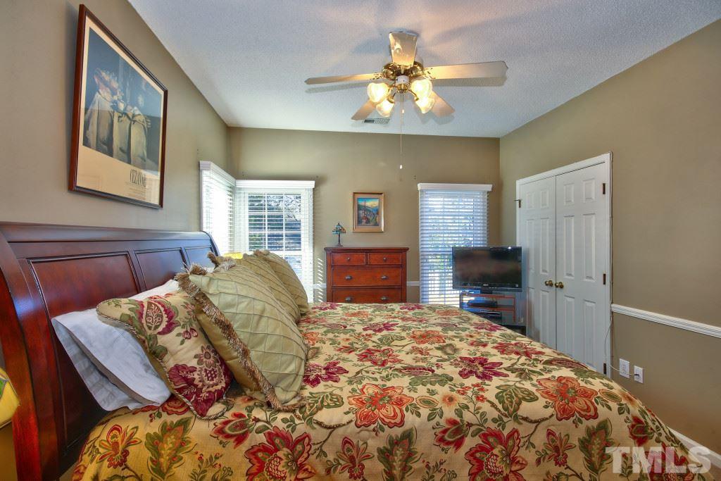 12225 Jarden Court Raleigh, NC 27613 - Photo 10 of 20 a bedroom with a bed and a chandelier