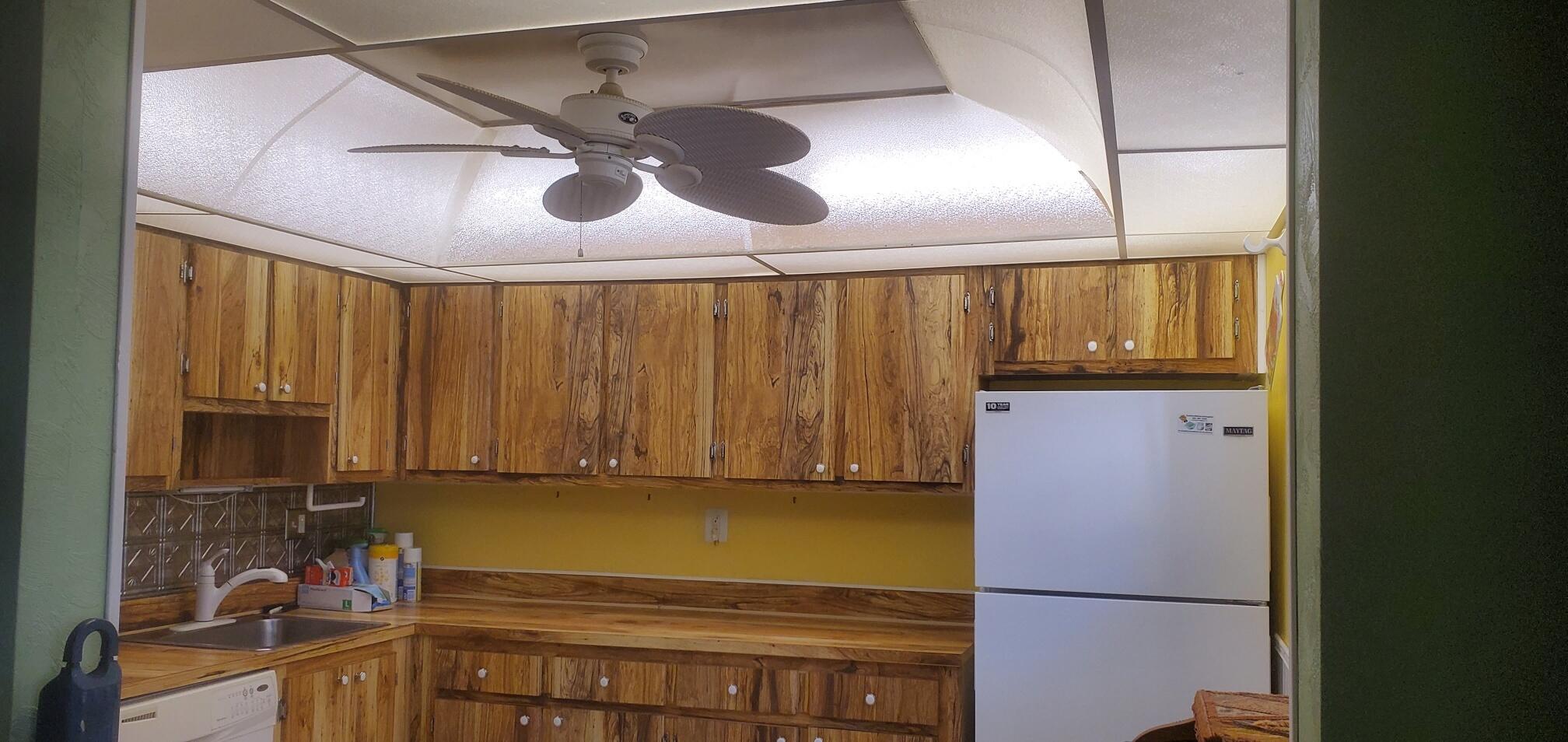 214 Capri East Delray Beach, FL 33484 - Photo 4 of 20 a kitchen with a refrigerator and a sink