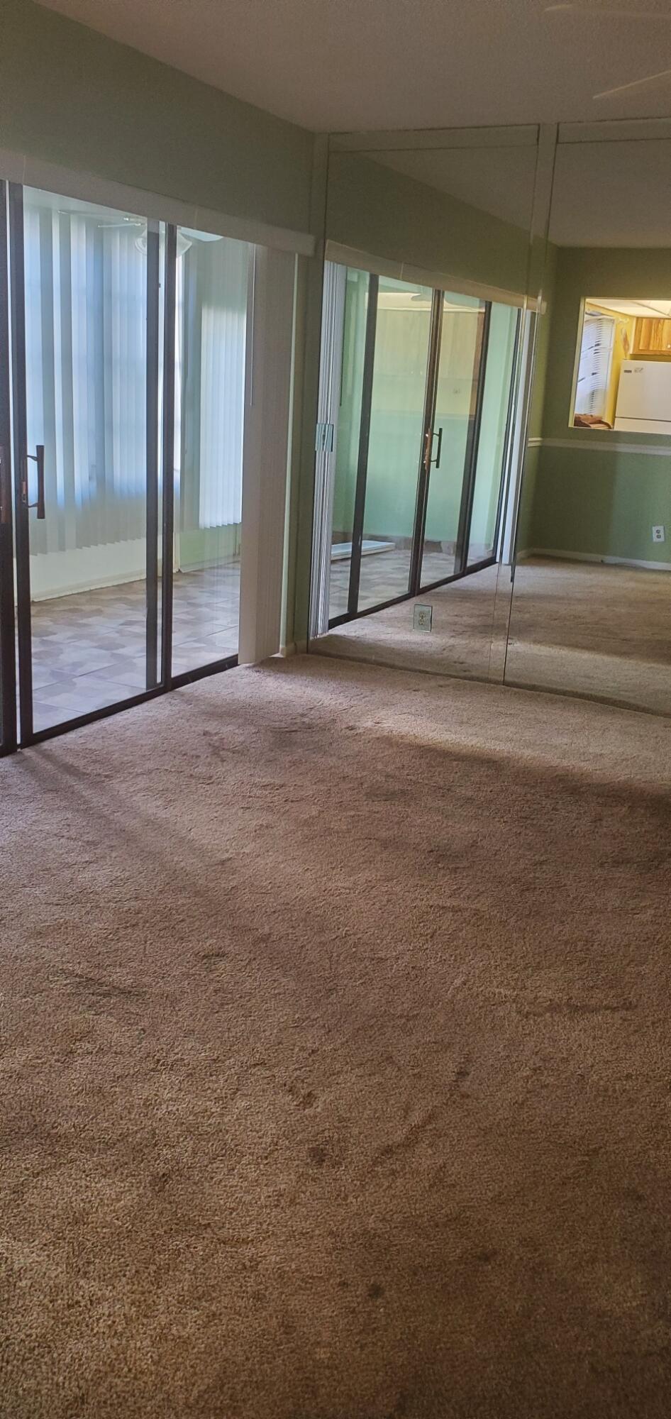 214 Capri East Delray Beach, FL 33484 - Photo 7 of 20 a view of an empty room with a fireplace and a window