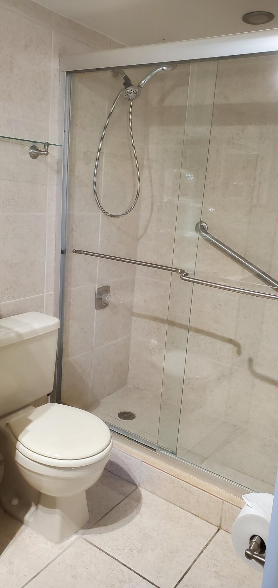 214 Capri East Delray Beach, FL 33484 - Photo 9 of 20 a white toilet next to a bathroom