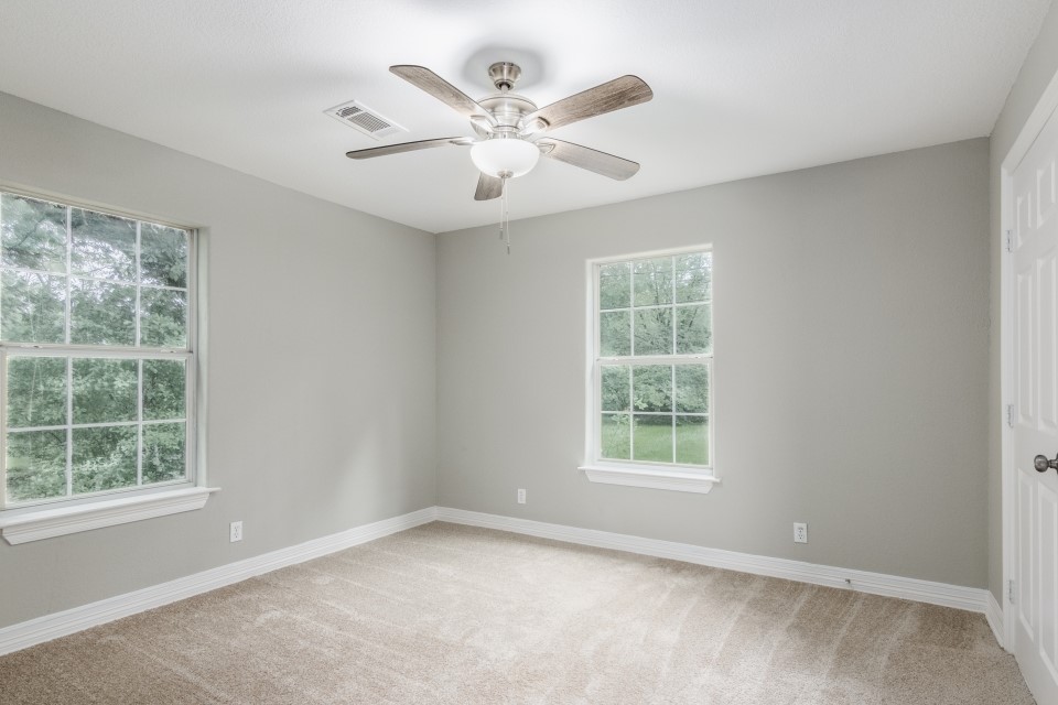 512 North Inwood Drive Bridge City, TX 77611 - Photo 16 of 18 an empty room with windows and ceiling fan