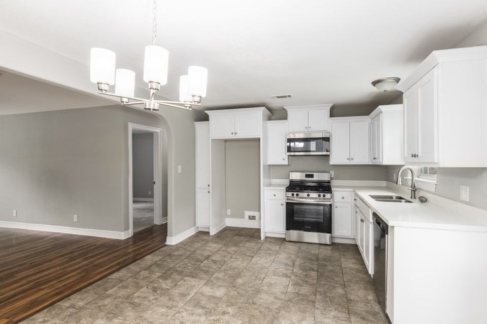 512 North Inwood Drive Bridge City, TX 77611 - Photo 8 of 18 a kitchen with kitchen island granite countertop a sink cabinets and stainless steel appliances