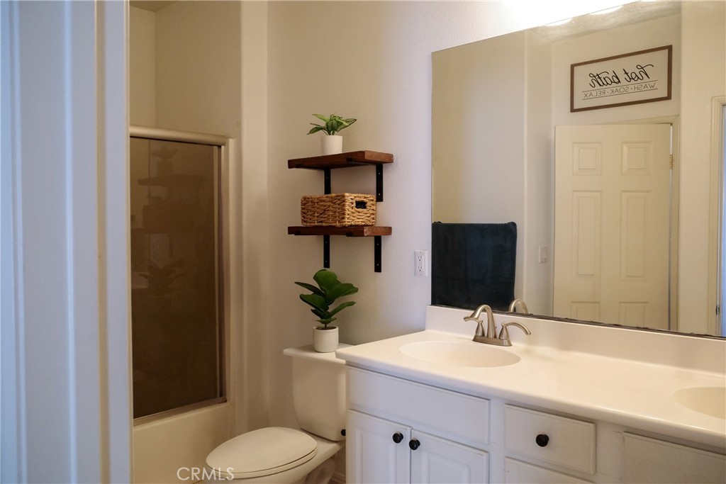 7331 Shelby Place Rancho Cucamonga, CA 91739 - Photo 14 of 17 a bathroom with a granite countertop sink toilet and mirror