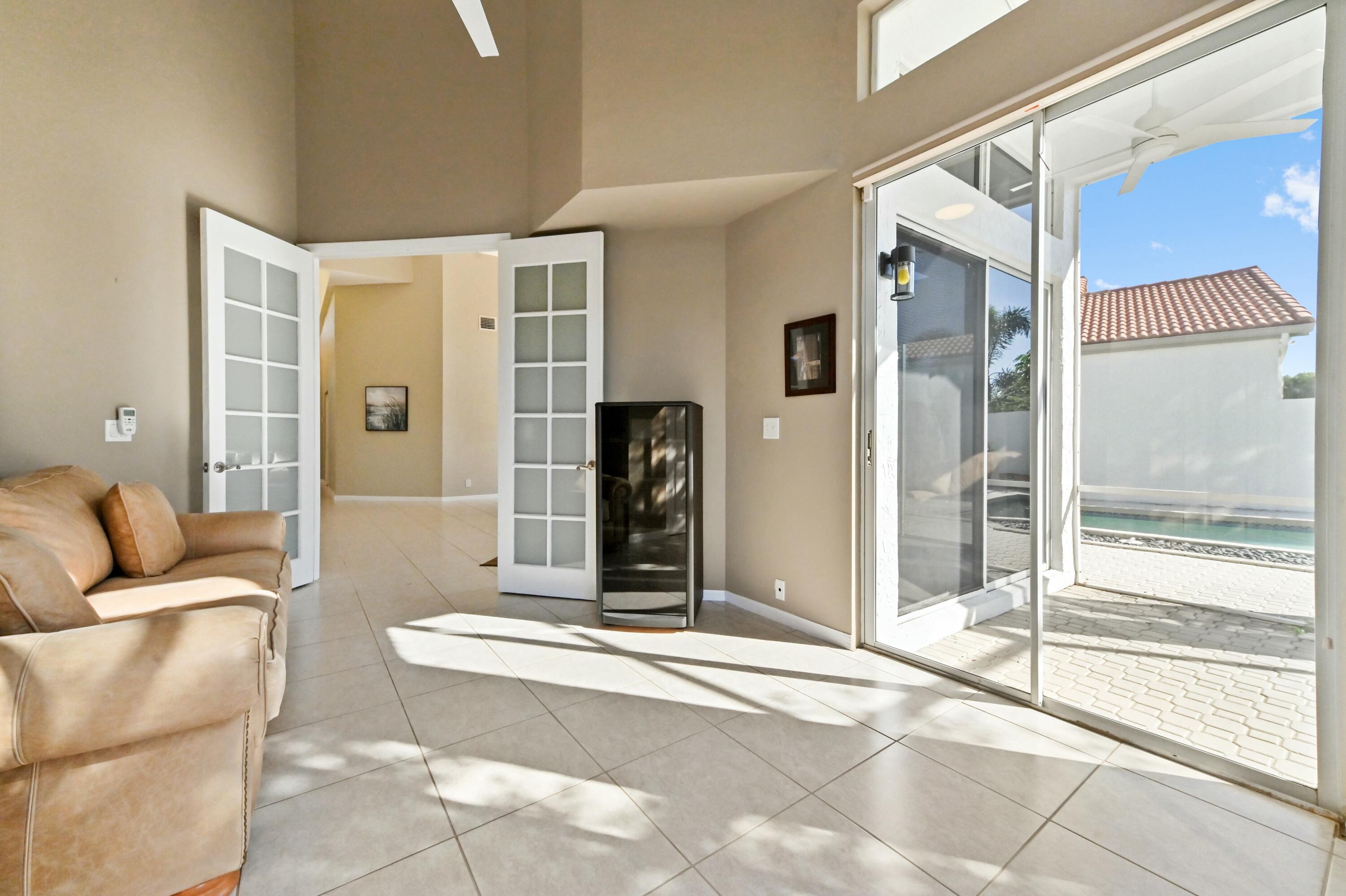 17272 Hampton Boulevard Boca Raton, FL 33496 - Photo 19 of 33 a living room with a couch and a large window