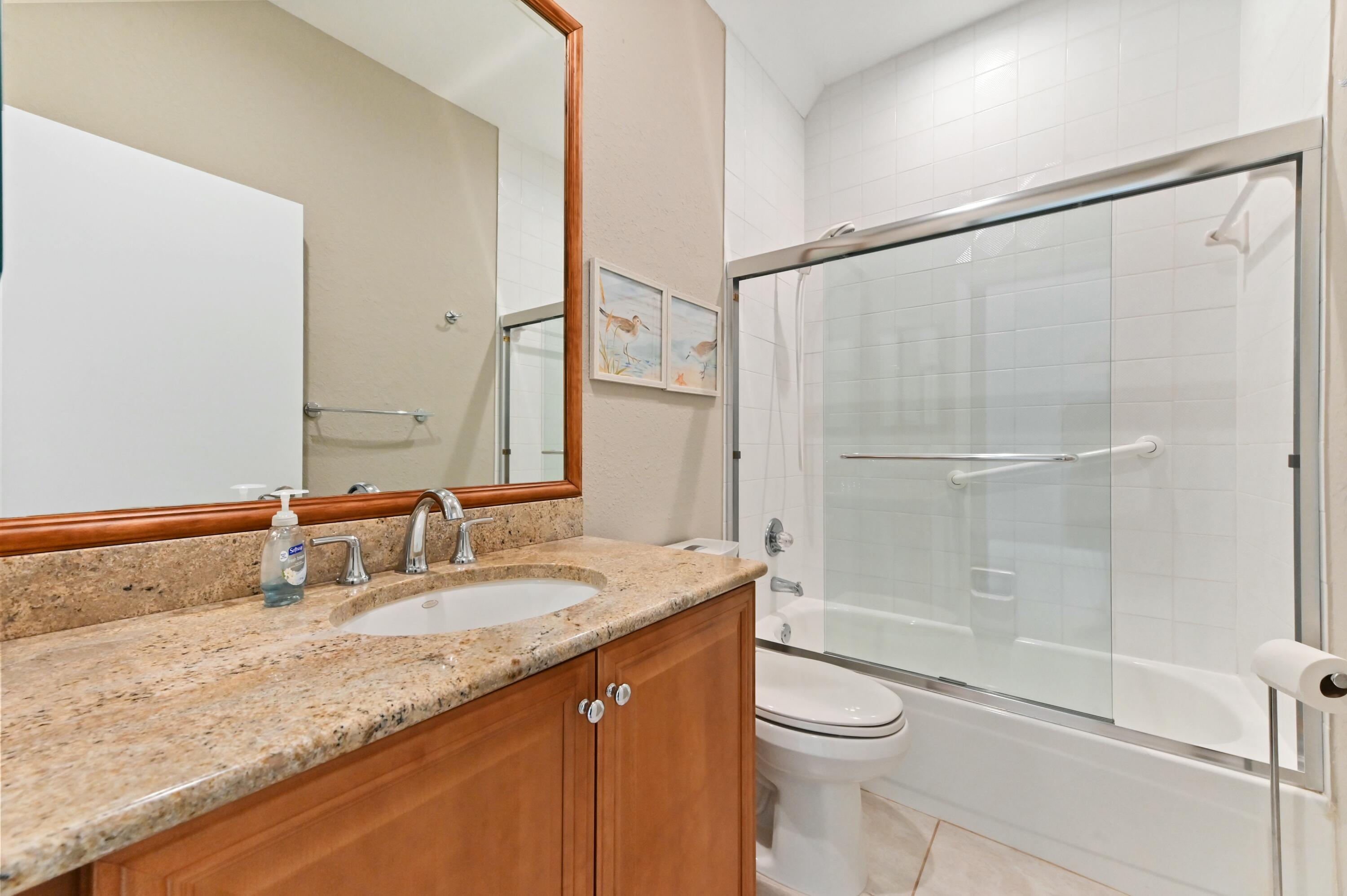 17272 Hampton Boulevard Boca Raton, FL 33496 - Photo 20 of 33 a bathroom with a granite countertop sink toilet and shower