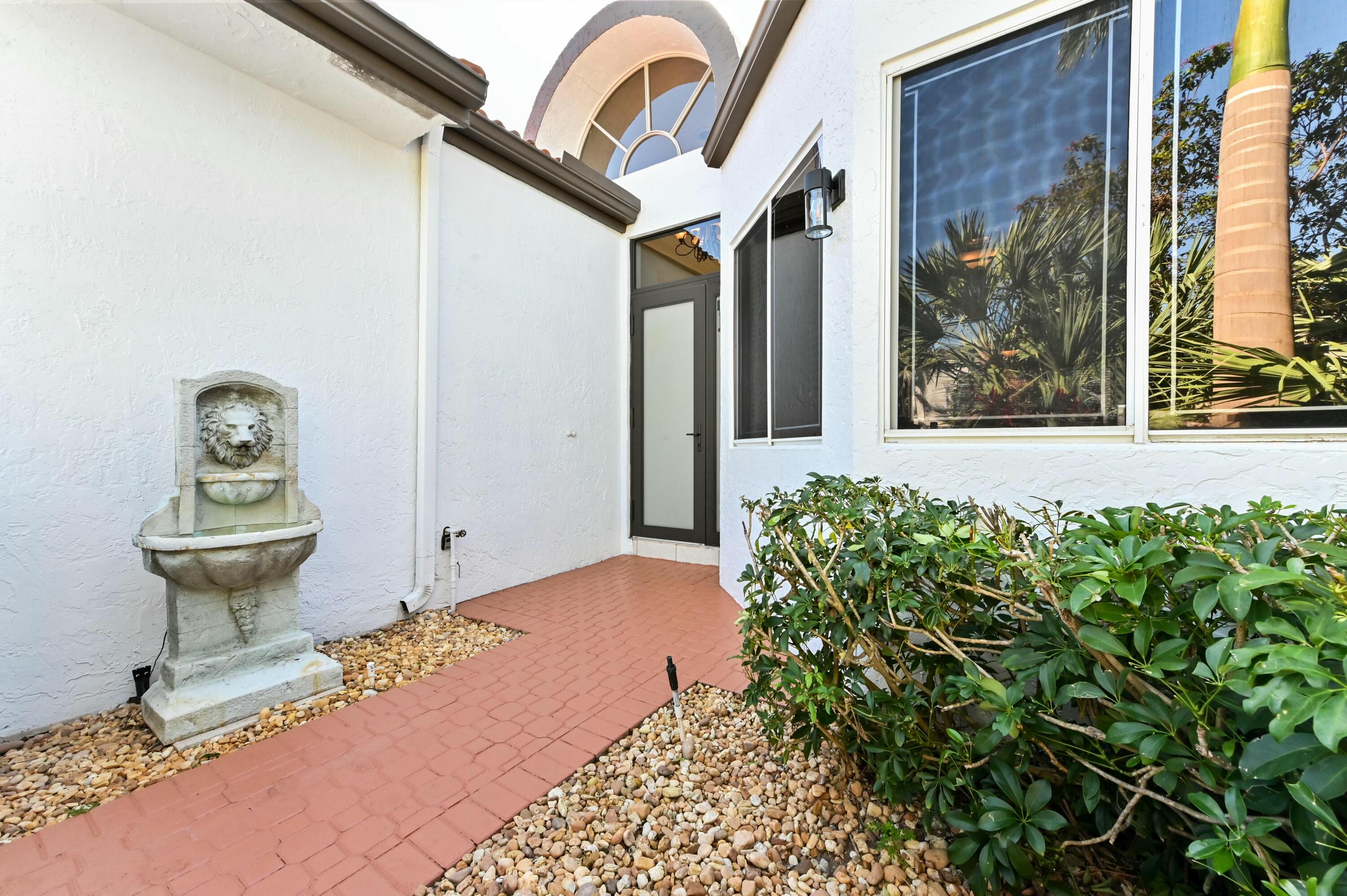 17272 Hampton Boulevard Boca Raton, FL 33496 - Photo 5 of 33 a front view of a house with garden