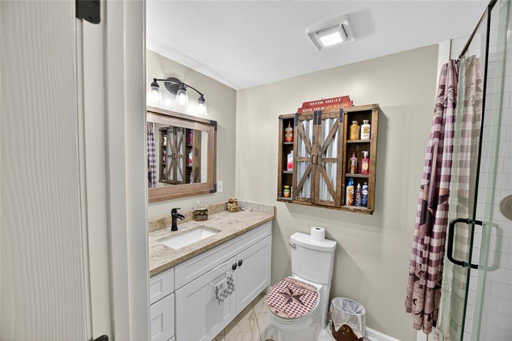 76 Walker Road Northwest Cartersville, GA 30121 - Photo 15 of 33 a bathroom with a granite countertop toilet sink and mirror