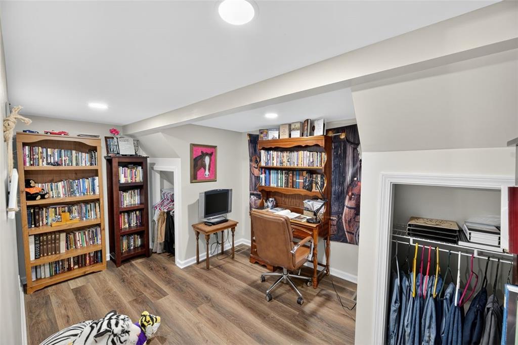 76 Walker Road Northwest Cartersville, GA 30121 - Photo 18 of 33 a view of a workspace with furniture and book shelf