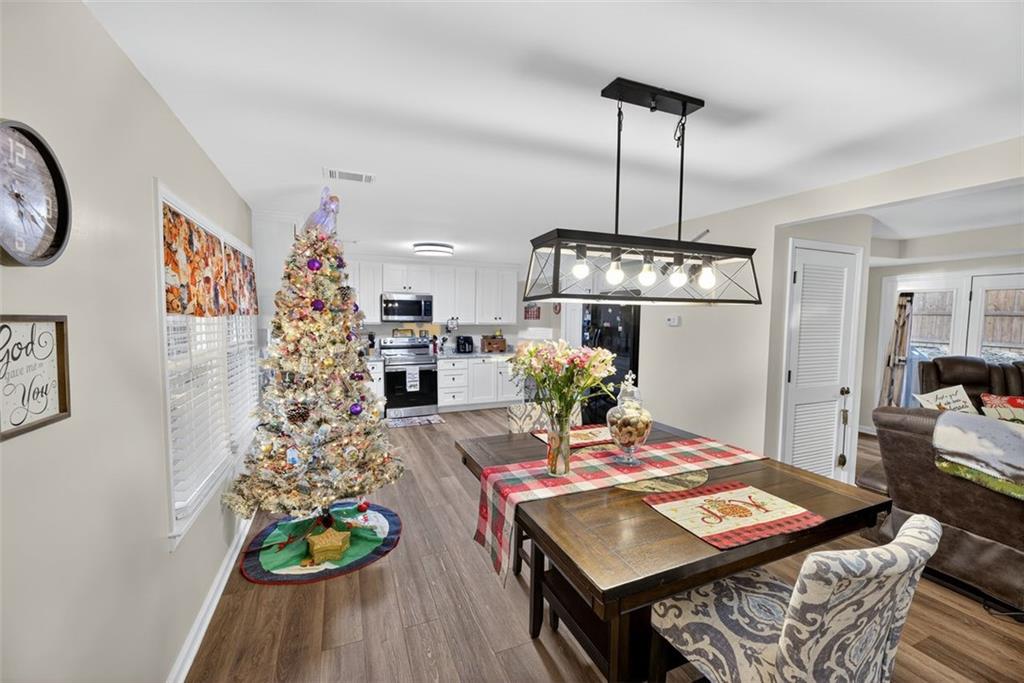 76 Walker Road Northwest Cartersville, GA 30121 - Photo 8 of 33 a view of a dining room with furniture and wooden floor