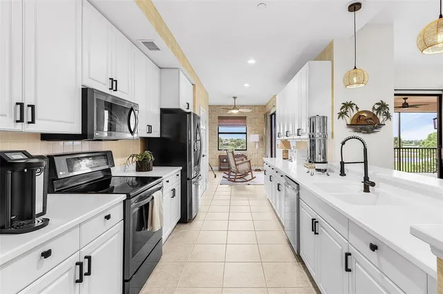 a large kitchen with stainless steel appliances lots of counter space sink and cabinets