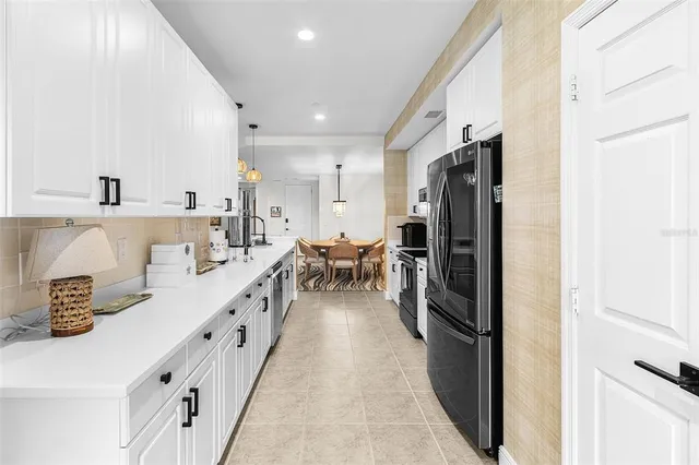 a kitchen with refrigerator and cabinets